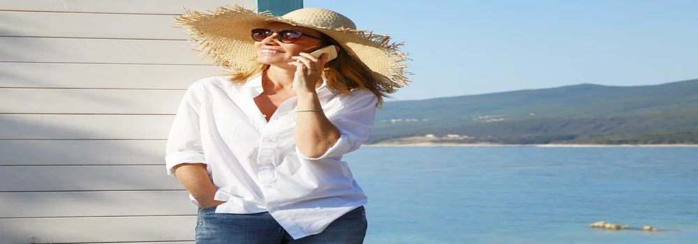 Telefonierende Frau am Meer