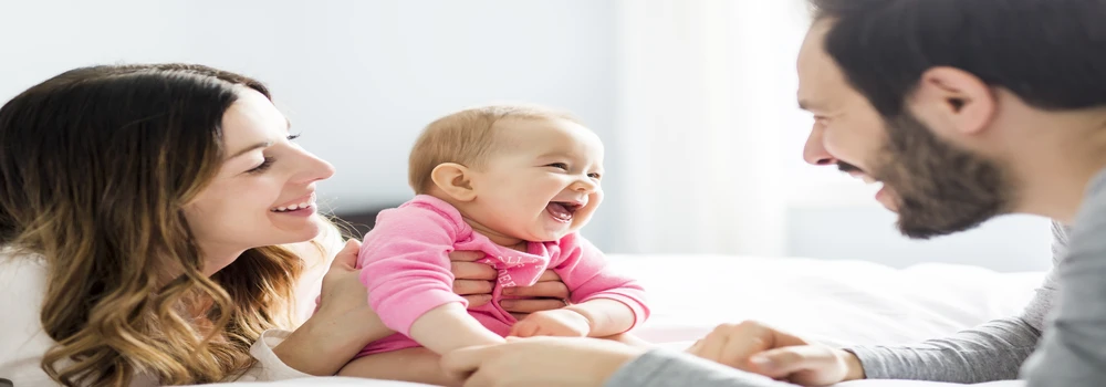Vater und Mutter mit einem lachenden Baby